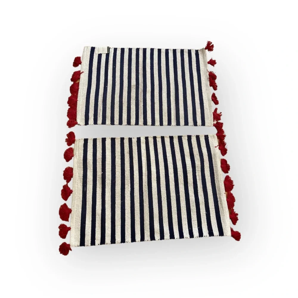 Two door mats with red tassels (used condition)